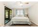 Bright bedroom features a queen bed, ceiling fan, and sliding door to the screened porch at 220 Clubhouse Dr. # 20B, Sunset Beach, NC 28468