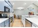 Stylish kitchen with stainless steel appliances, modern faucet, and a view to the adjacent dining area at 220 Clubhouse Dr. # 20B, Sunset Beach, NC 28468