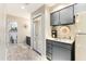 Kitchenette features gray cabinetry, sink, coffee maker and a full size refrigerator at 220 Clubhouse Dr. # 20B, Sunset Beach, NC 28468