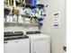 Laundry room with side-by-side washer and dryer, storage shelves, and laundry supplies at 220 Clubhouse Dr. # 20B, Sunset Beach, NC 28468