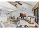 Bright living room with vaulted ceilings, ceiling fan, modern furniture, and view into dining area at 220 Clubhouse Dr. # 20B, Sunset Beach, NC 28468