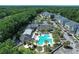 Aerial view of a large pool, sundeck, and palm trees at the community recreation center at 220 Clubhouse Dr. # 20B, Sunset Beach, NC 28468