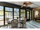 Enclosed porch with glass windows, dining table set with seating for four at 220 Clubhouse Dr. # 20B, Sunset Beach, NC 28468