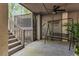 Inviting porch with lattice detail, swing, and outdoor seating, ideal for relaxation and enjoying the surroundings at 220 Clubhouse Dr. # 20B, Sunset Beach, NC 28468