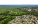 Overhead view of the community nestled within wooded terrain; the property is highlighted in red at 234 Belmonte Dr., Myrtle Beach, SC 29588