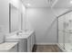 Well-lit bathroom with double sink vanity, wood-look floors, and glass shower at 234 Belmonte Dr., Myrtle Beach, SC 29588