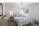 Stylish bedroom featuring a decorative chandelier, accent lamps, and modern furniture at 234 Belmonte Dr., Myrtle Beach, SC 29588