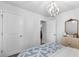 A bedroom with modern mirror, chandelier, and decor, capturing style and functionality at 234 Belmonte Dr., Myrtle Beach, SC 29588