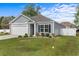 Well-manicured front lawn and landscaping surround this charming home with grey siding at 234 Belmonte Dr., Myrtle Beach, SC 29588
