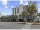 Attractive multi-story building, with palm trees, covered parking and beach access at 2401 S Ocean Blvd. S # 1256, Myrtle Beach, SC 29577