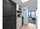 Efficient kitchen features a black refrigerator, and a view into the bedroom at 2401 S Ocean Blvd. S # 1256, Myrtle Beach, SC 29577