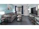 Comfortable living room boasts a gray sofa, mounted TV, and blue accent walls at 2401 S Ocean Blvd. S # 1256, Myrtle Beach, SC 29577