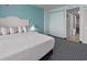 Inviting bedroom with a serene ambiance, featuring a white bed and soft lighting at 2401 S Ocean Blvd. S # 1256, Myrtle Beach, SC 29577