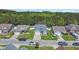 Aerial view of home showcasing well-manicured front lawn, landscaping, and surrounding neighborhood at 254 Tall Palms Way, Little River, SC 29566