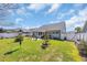 This expansive backyard includes a fenced perimeter and lush landscaping, offering privacy and space at 254 Tall Palms Way, Little River, SC 29566