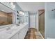 Stylish bathroom featuring a dual sink vanity, large mirror, decorative turtles and a glass-enclosed shower at 254 Tall Palms Way, Little River, SC 29566