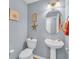 Cozy half bathroom featuring a pedestal sink, oval mirror, and nautical-themed decorations at 254 Tall Palms Way, Little River, SC 29566