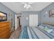 Comfortable bedroom featuring a bed, television on dresser, closet, and beach-themed decor at 254 Tall Palms Way, Little River, SC 29566