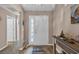 Front entryway with a white door, a rug, and a side table with beach-themed decor at 254 Tall Palms Way, Little River, SC 29566