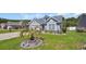 Charming home featuring a well-manicured lawn and established landscaping with a decorative rock garden at 254 Tall Palms Way, Little River, SC 29566