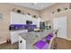 Modern kitchen with stainless steel appliances, granite countertops, and breakfast bar seating at 254 Tall Palms Way, Little River, SC 29566