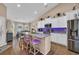 Modern kitchen with a granite island, stainless steel appliances, and a dining area with lots of light at 254 Tall Palms Way, Little River, SC 29566