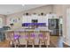 Modern kitchen with a granite island, stainless steel appliances, and white cabinets at 254 Tall Palms Way, Little River, SC 29566
