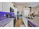 Bright kitchen featuring granite counters, modern appliances, tile flooring, and white cabinets at 254 Tall Palms Way, Little River, SC 29566