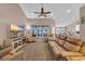 Spacious living room featuring a ceiling fan, comfortable seating, and a view into the kitchen at 254 Tall Palms Way, Little River, SC 29566