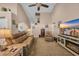 Inviting living room with high ceilings, neutral tones, a ceiling fan, and a cozy fireplace at 254 Tall Palms Way, Little River, SC 29566