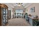 Cozy office with lots of plants, natural light, neutral tones, and a ceiling fan at 254 Tall Palms Way, Little River, SC 29566