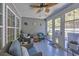 Relaxing sunroom features wicker furniture, neutral walls, and a ceiling fan for ultimate comfort at 254 Tall Palms Way, Little River, SC 29566