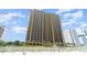 Striking high-rise condo showcasing numerous balconies and exterior details, bordered by lush greenery at 2600 N Ocean Blvd. # 1401, Myrtle Beach, SC 29577