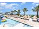 Inviting outdoor pool area complete with lounge chairs, palm trees, and ocean views, perfect for relaxation at 2600 N Ocean Blvd. # 1401, Myrtle Beach, SC 29577