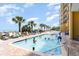 Gathering-friendly pool area with sparkling water, palm trees, and plenty of space for fun in the sun at 2600 N Ocean Blvd. # 1401, Myrtle Beach, SC 29577