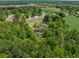 Lush green tree canopy around the property, aerial view, with a pool and driveway at 2865 N Nichols Hwy., Nichols, SC 29581