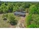 Aerial view showcasing the house surrounded by verdant trees, a large lot, and a shed in the back at 2865 N Nichols Hwy., Nichols, SC 29581