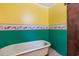 Retro bathroom featuring a yellow and green design, and a classic clawfoot tub at 2865 N Nichols Hwy., Nichols, SC 29581