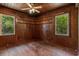 Bedroom with hardwood floors, wood paneling, and natural light from the windows at 2865 N Nichols Hwy., Nichols, SC 29581