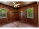 Bedroom with wood paneling, hardwood floors, and windows at 2865 N Nichols Hwy., Nichols, SC 29581