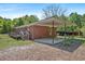 Rear exterior view of a brick home with a covered patio and wooden deck at 2865 N Nichols Hwy., Nichols, SC 29581