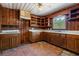 Traditional kitchen featuring wood paneling, tile floors, and a window over the sink at 2865 N Nichols Hwy., Nichols, SC 29581
