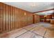 View of a living room with wood paneling leading into kitchen, showing renovation potential at 2865 N Nichols Hwy., Nichols, SC 29581