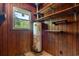 Utility room with water heater, wood paneling and some wood shelving for storage at 2865 N Nichols Hwy., Nichols, SC 29581