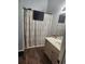 Well-lit bathroom features a vanity with storage and a shower with patterned shower curtain at 328 Harbour Reef Dr., Myrtle Beach, SC 29588