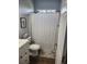 Bathroom features a shower/tub combo with patterned curtain, and a vanity with wood storage; neutral colors at 328 Harbour Reef Dr., Myrtle Beach, SC 29588