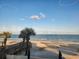 Scenic beach view with palm trees, ocean waves, and clear blue sky at 328 Harbour Reef Dr., Myrtle Beach, SC 29588