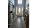 Inviting foyer with wood-look tile flooring, decorative plants, and a stylish front door at 328 Harbour Reef Dr., Myrtle Beach, SC 29588
