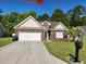Charming single-story brick home featuring a well-manicured lawn and attached two-car garage at 328 Harbour Reef Dr., Myrtle Beach, SC 29588