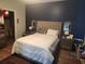 Comfortable main bedroom with a plush bed, accent wall, and side tables; wood flooring at 328 Harbour Reef Dr., Myrtle Beach, SC 29588